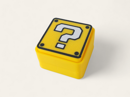 Clicador Power-Up de Mario Bros de la marca Kokoroto, con diseño inspirado en personajes del videojuego.