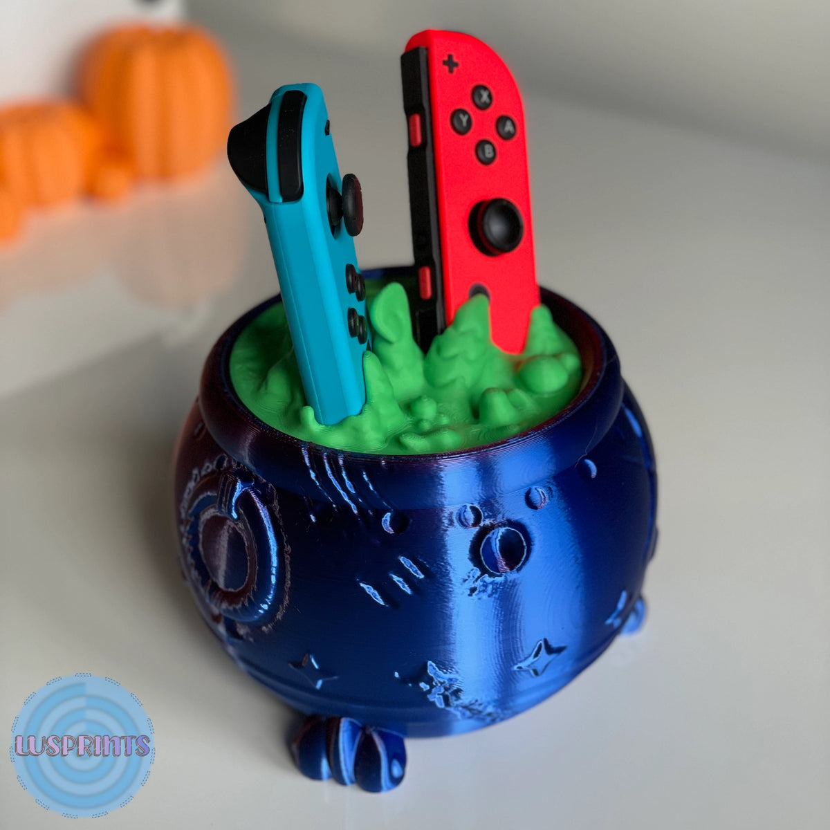 Witch's cauldron for Joy-Con in metallic blue with the controllers in place, angled view - Kokoroto