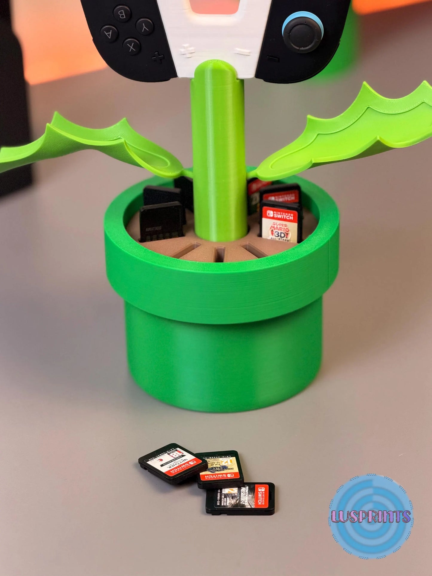 Soporte de planta Piraña para Joy-Cons de Switch 2 de la marca Kokoroto, con diseño de Piraña de Mario en color negro.